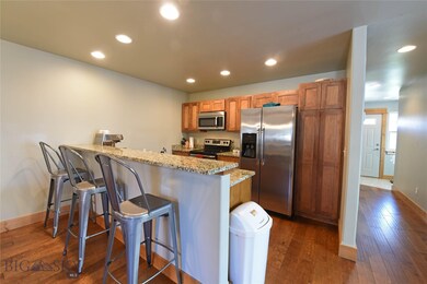 Open kitchen with eating bar, alder cabinets, gran