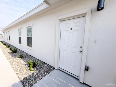 Entrance to property with stucco siding