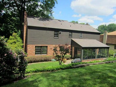 Exterior Back. Attached 3-season room, lighted fla