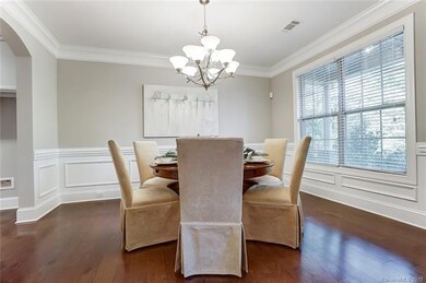 Formal Dining Room with arched entries, wood floor
