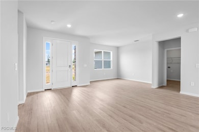 Entrance foyer featuring light wood finished floors and recessed lighting