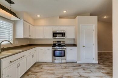 Kitchen with light wood-style tile flooring, white