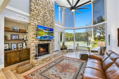 Living room with a high ceiling, a ceiling fan, a