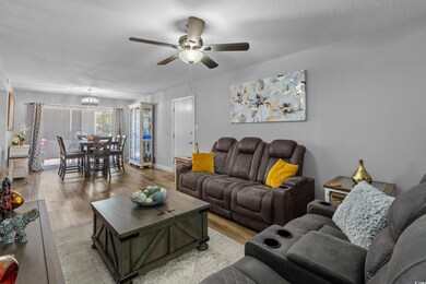 Living area featuring baseboards, light wood-style