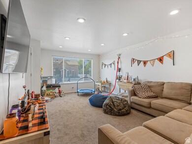 Duplex unit carpeted living room with recessed lighting
