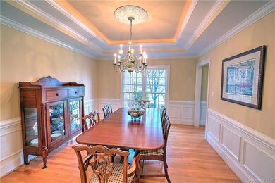 The dining room  off of the two-story foyer featur