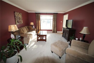 The living room has a box bay window, crown moldin