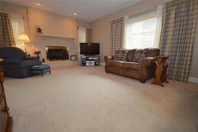 Comfortable family room has a floor-to-ceiling hea