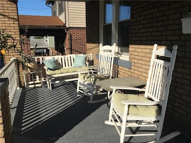 Inviting front porch with new carpeting.