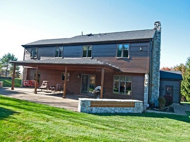 natural cedar and stone exterior and covered patio