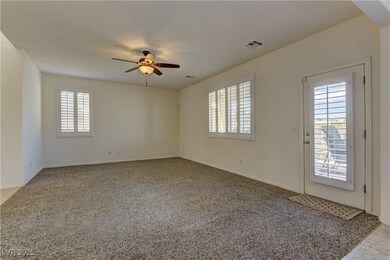 Unfurnished room featuring ceiling fan, carpet, an