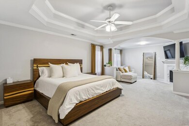 Head upstairs to the Oversized Owner's Suite, complete with a Tray Ceiling, Sitting Area with a Modern Stone Fireplace, and Two Large Walk-In Closets.