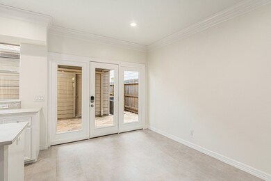 The breakfast room features elegant crown molding,