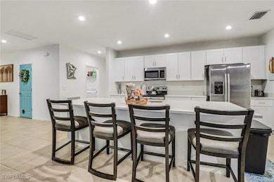 Kitchen featuring a kitchen bar, a large island wi