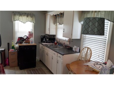 KITCHEN FROM LIVING ROOM DOORWAY.  DISHWASHER BELO