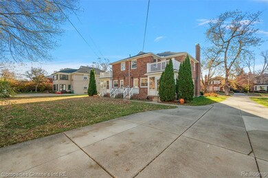 View of front of property featuring brick siding, a front lawn, and a chimney