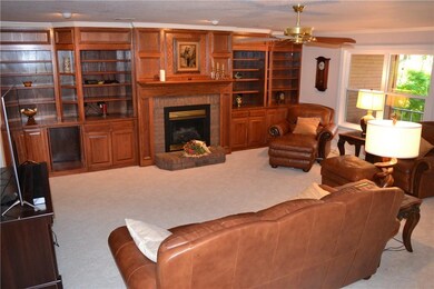 Family room has energy efficient vent-less gas fireplace and wall to wall custom built-in cabinetry.
