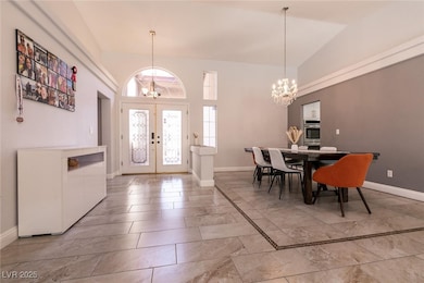 Dining room with a chandelier, french doors, baseb