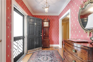 Entrance hall with hardwood floors and dentil crow