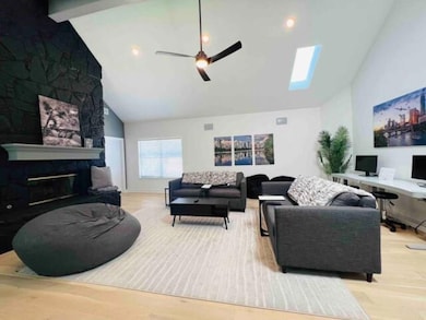 Living room featuring wood finished floors, a cei