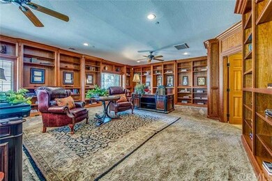 Handsome custom wood-paneled library with bay wind