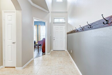 Welcoming foyer with high ceilings and elegant cro
