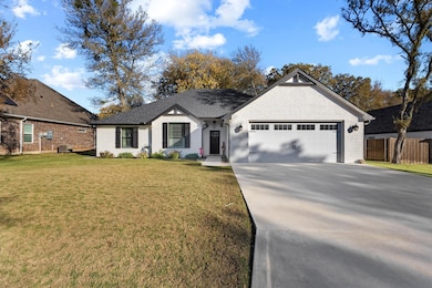 Ranch-style house featuring brick siding, concrete driveway, and a garage