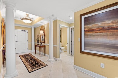 Foyer entrance with light tile patterned floors an