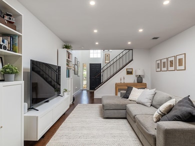 Living area with stairs, recessed lighting, and d