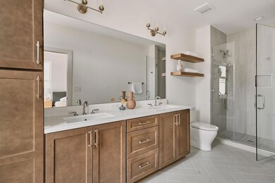 Bathroom with a stall shower, visible vents, and 