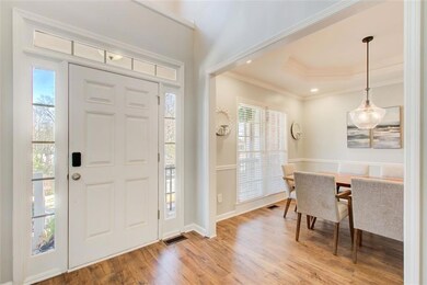 Formal dining room with trey ceiling and modern li