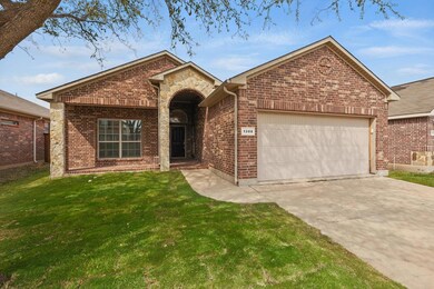 Ranch-style house with stone siding, driveway, a f