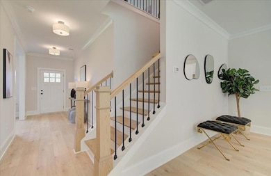 Foyer featuring baseboards, wood finished floors, 