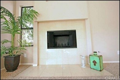 The tile-accented fireplace acts as the focal poin