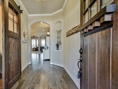 Simply STUNNING!  Come inside this beautiful home which with WoodFflooring, gorgeous Neutral Paint, Custom Barn Doors, Crown Molding, and gorgeous Arched Doorways throughout the home.