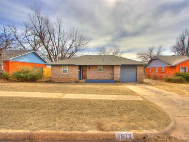 Single story home with a front lawn and a garage