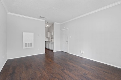Unfurnished living room featuring dark wood-style