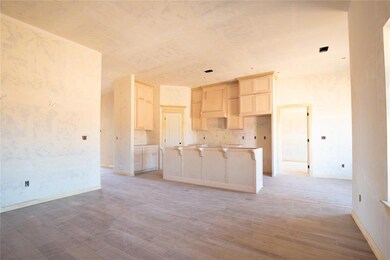Kitchen featuring backsplash, light wood-type flooring, and a center island