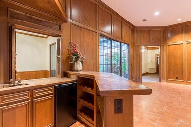 Executive style wet bar with sink and beverage fridge, wine rack, and storage.  This area has a pass-through into the Family Room. So many options for space -the living room also provides access to the interior atrium.  What a great space to hang out, relax, entertain or dine.  Endless possibilities...
