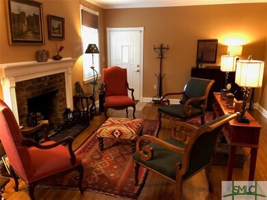 Living room looking to the entry.  Hardwood floors