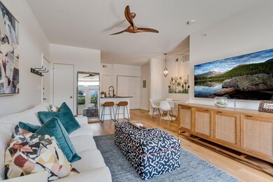 Living room with ceiling fan and light wood-type 