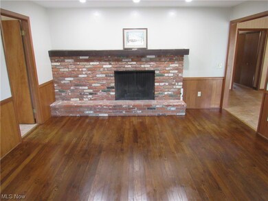 Unfurnished living room featuring a fireplace and dark wood-type flooring
