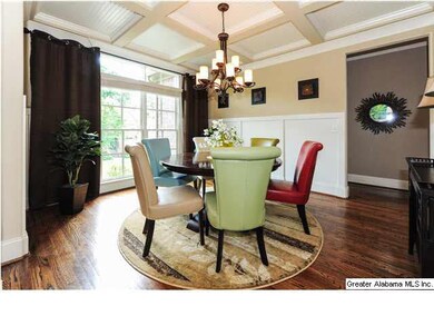 Beautiful dining room with coffered ceiling and ha