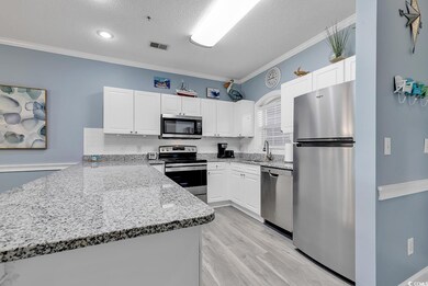 Kitchen with stainless steel appliances, white cab