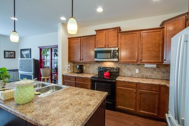 Kitchen has designer tile back splash