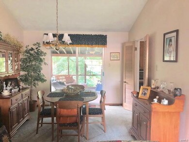 Dining room with sliding doors to the screened-in porch overlooking the backyard.