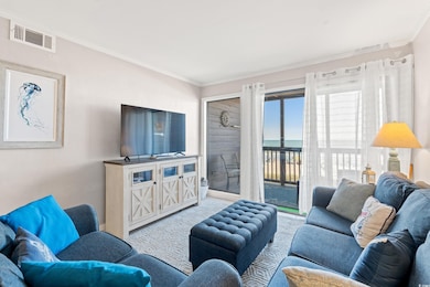 Living area featuring crown molding