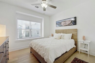 Bedroom with light wood finished floors and ceili