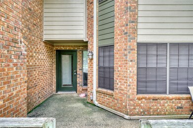 Doorway to property with brick siding