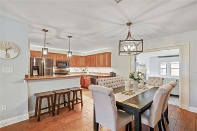 Breakfast bar and dining area with view of den.